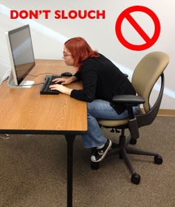 woman slouching over her keyboard 